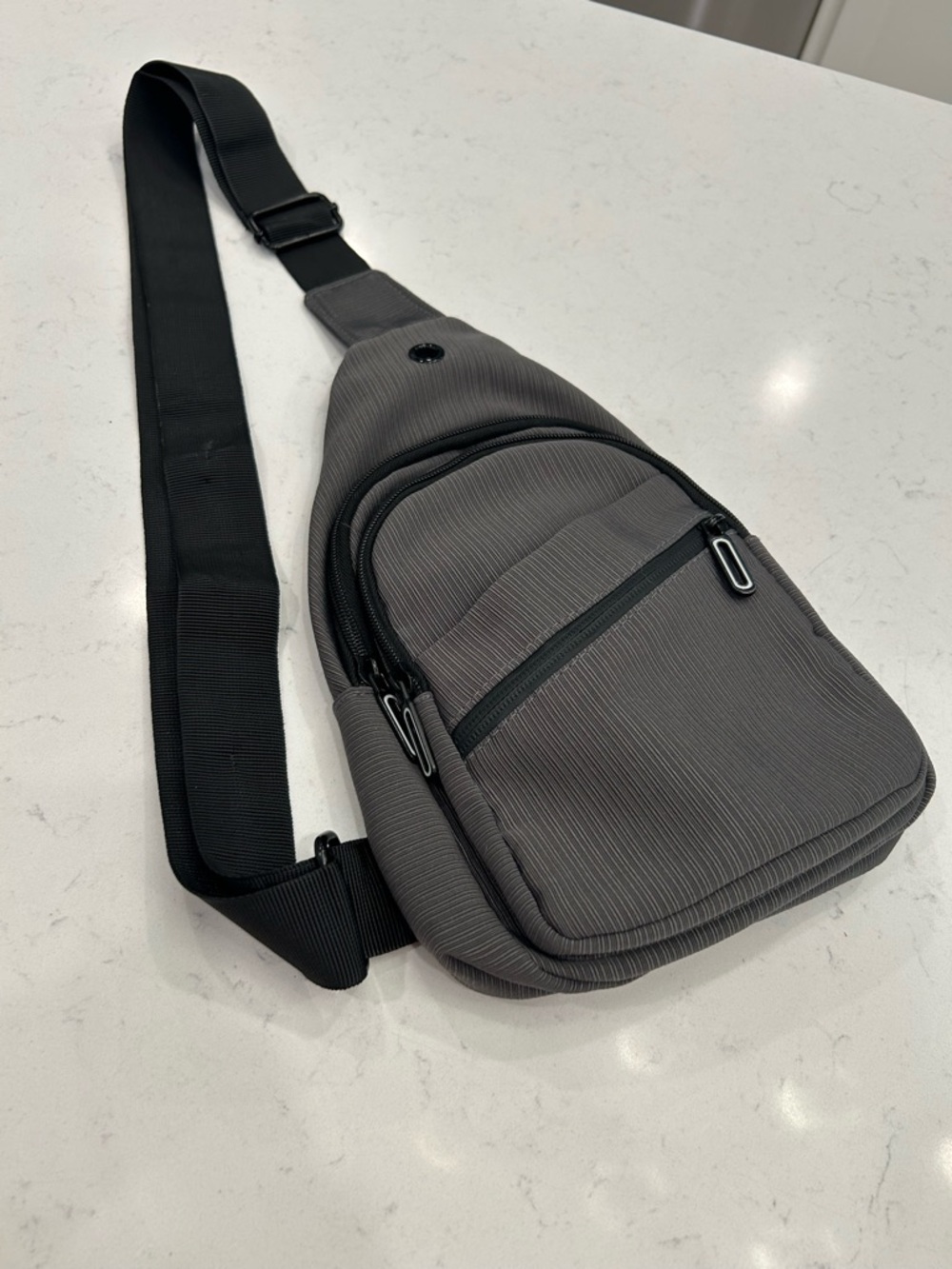 Sleek Gray Sling Bag with Adjustable Black Strap